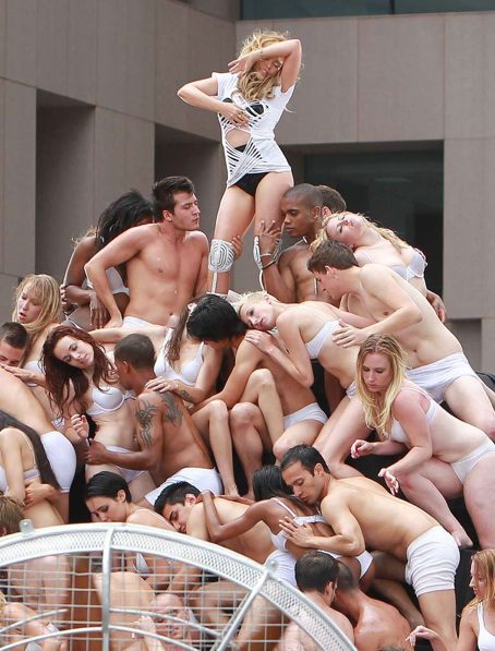 People in white posing creatively outdoors