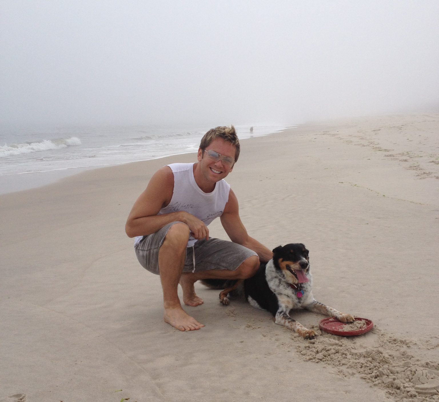 Man and dog playing with frisbee