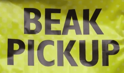 Yellow sign with "BEAK PICKUP" text