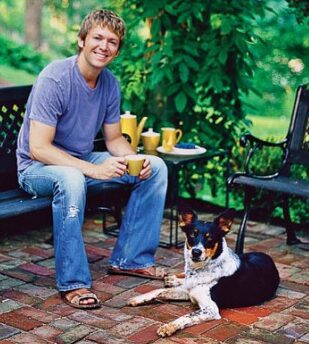 Man sitting with dog on patio