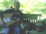 Person on bench with packages and dog
