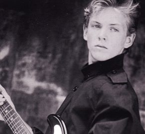 Young musician holding a guitar