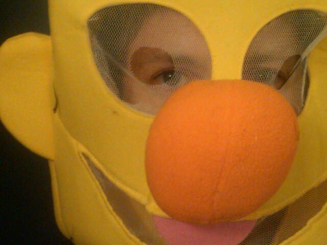 Child peering through character mask