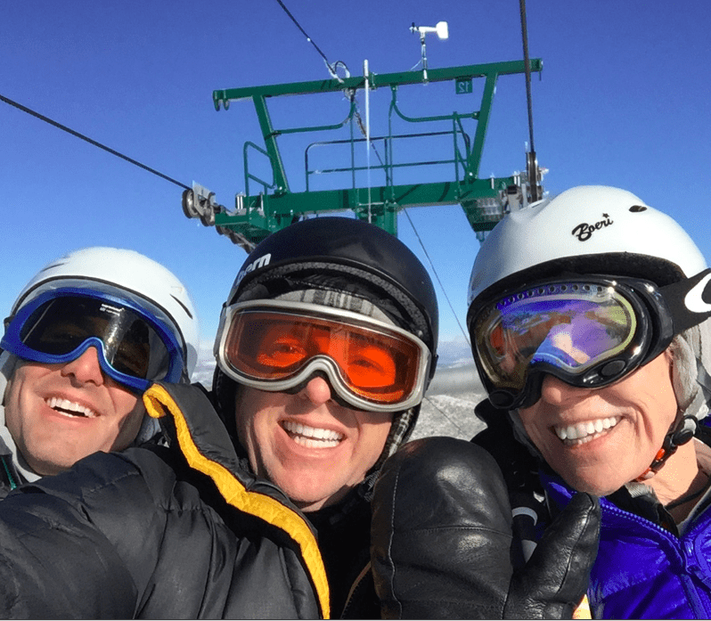 Skiers smiling on a snowy mountain