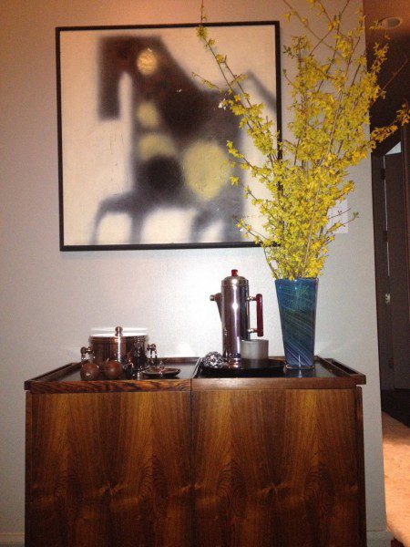 Wooden cabinet with art and flowers