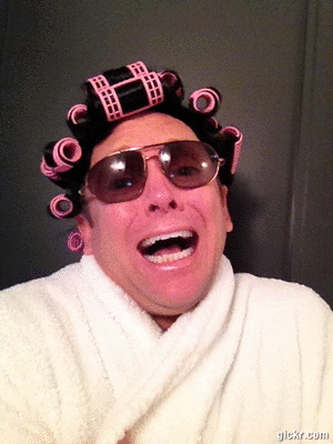 Laughing person with curlers and sunglasses