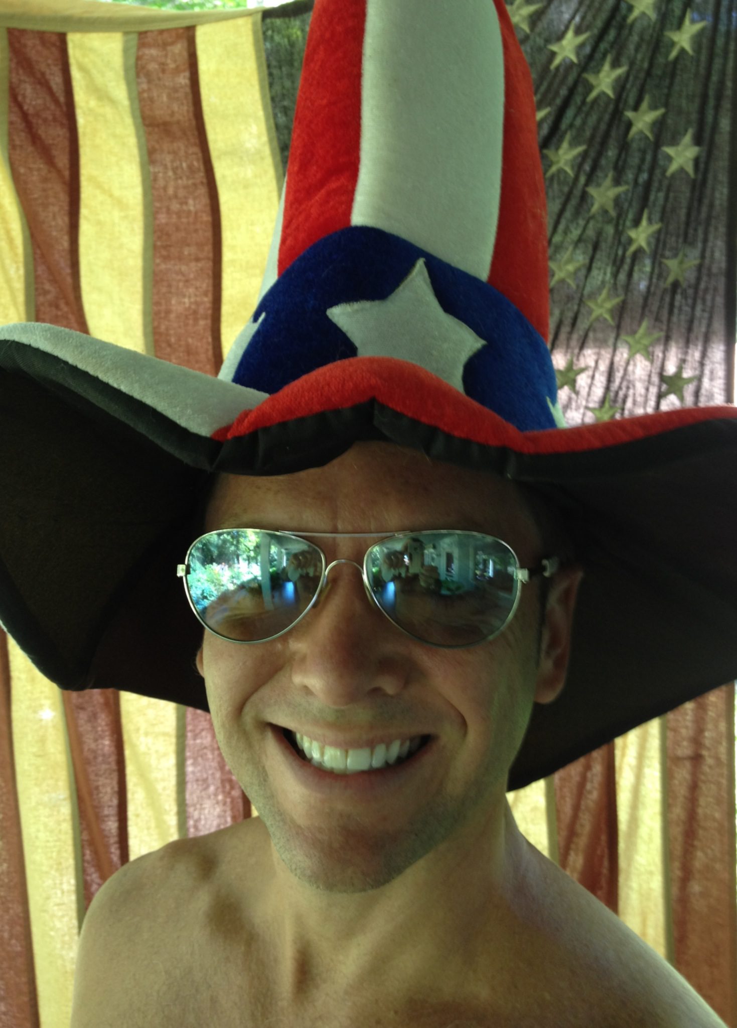 Man wearing patriotic hat and sunglasses