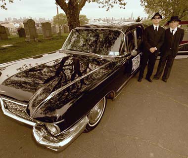 Vintage vehicle parked in cemetery setting