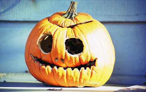 Cracked pumpkin with carved face