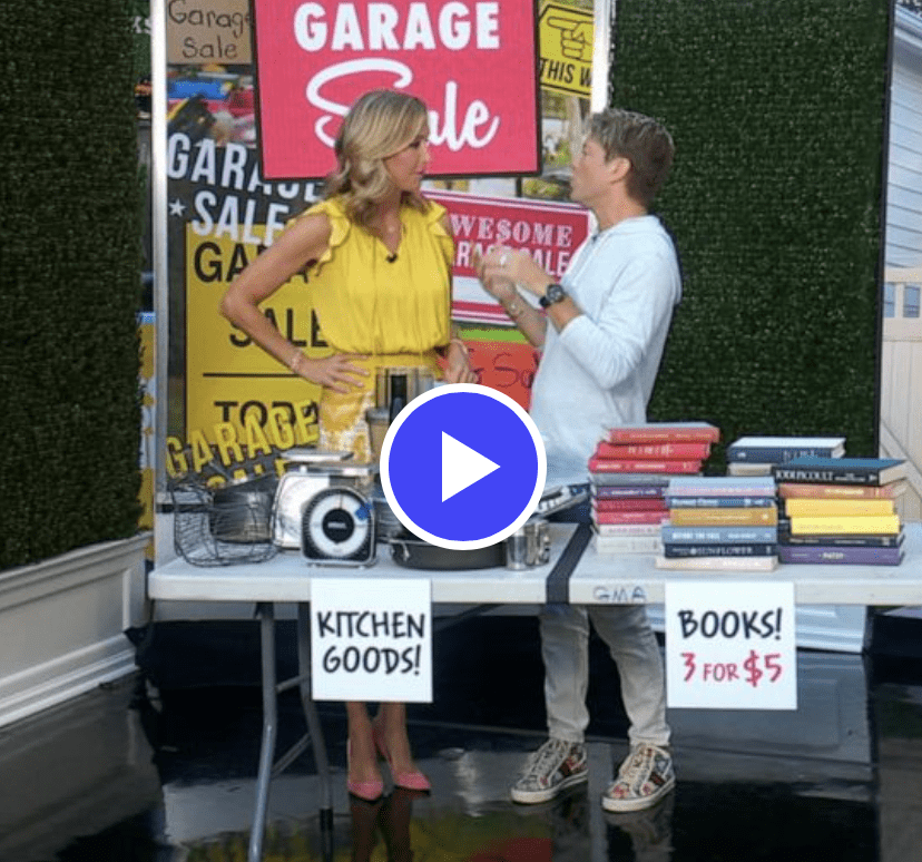 Garage sale with kitchen goods and books.