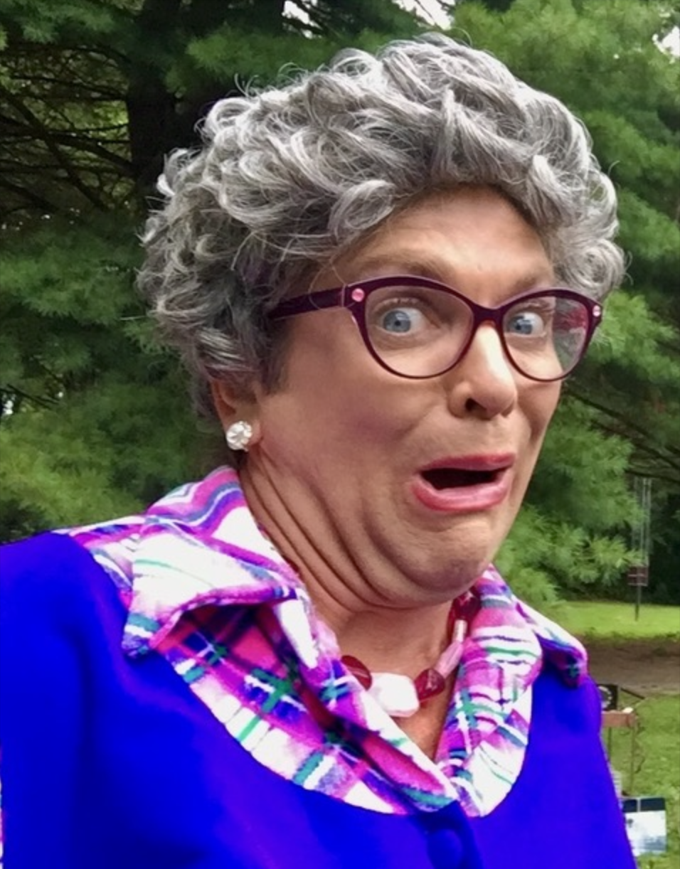 Elderly person with surprised expression outdoors.