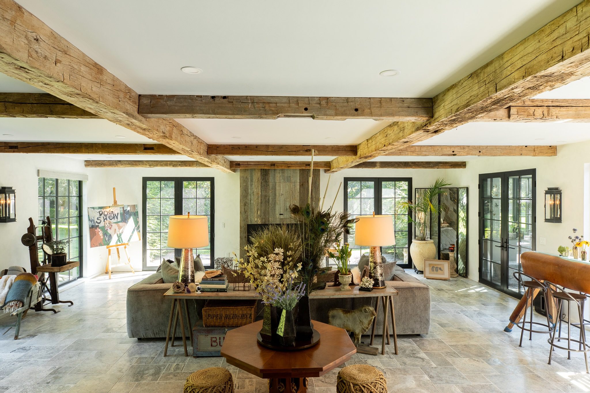 Spacious living room with rustic wooden beams.