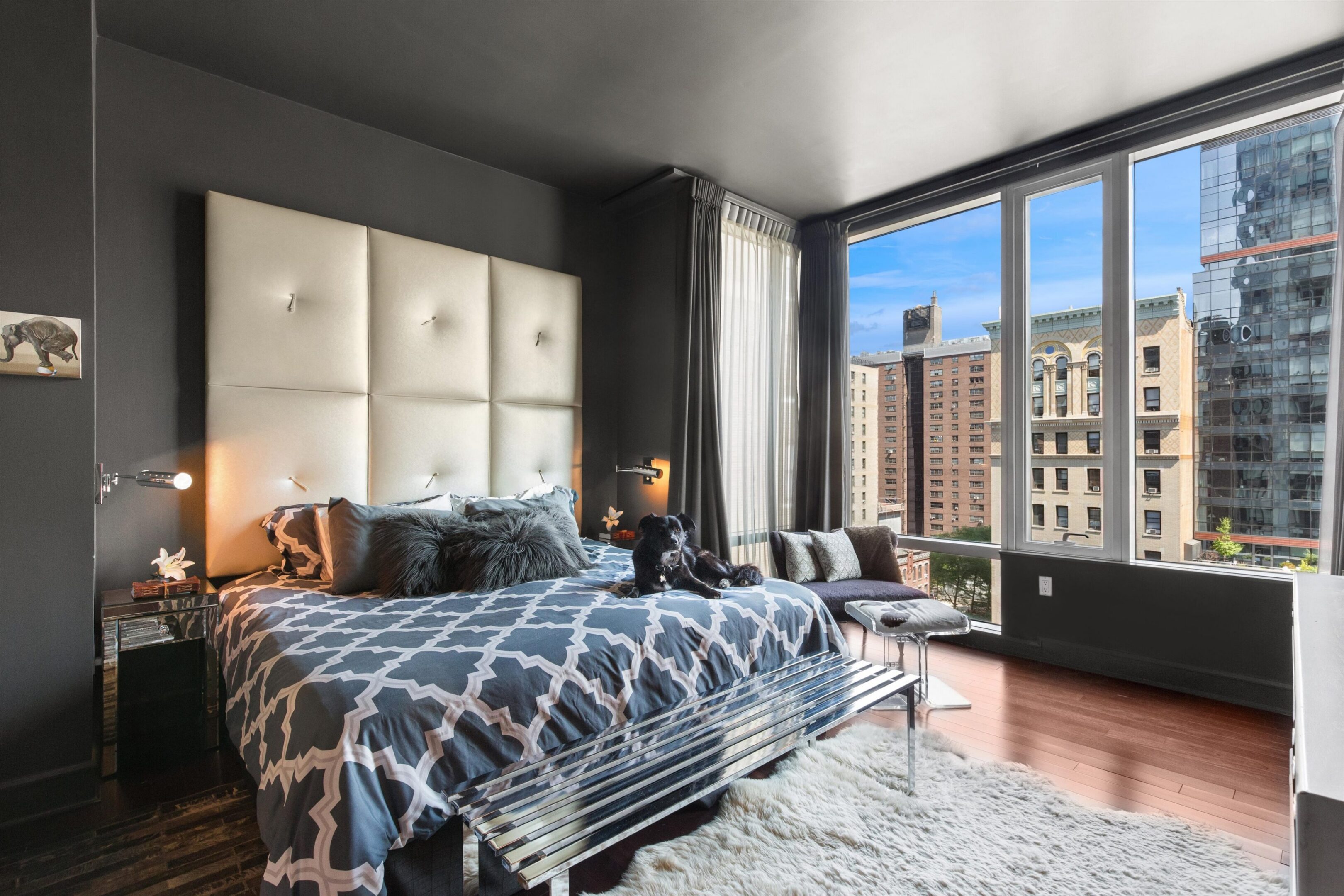 Modern bedroom with large window and city view.