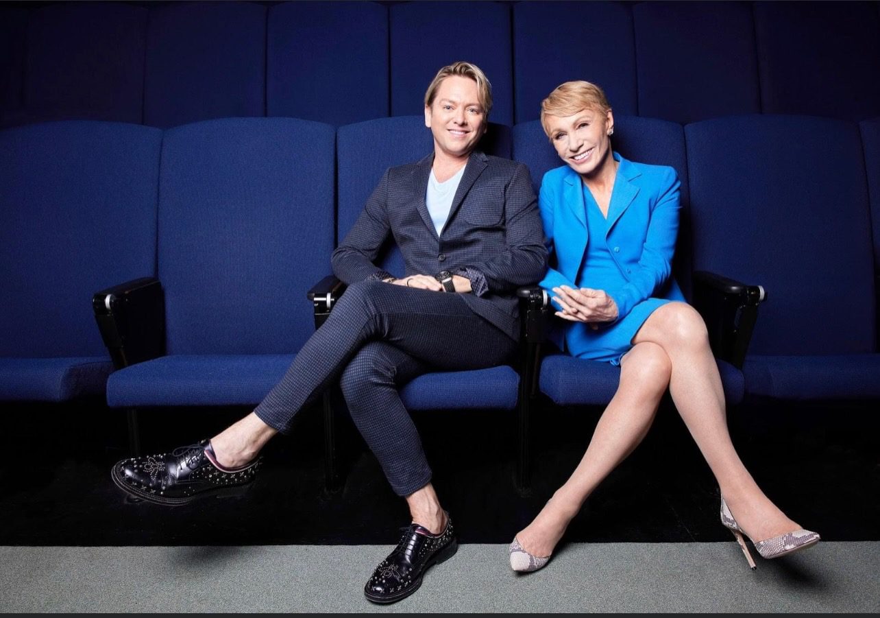 Two people seated in a theater.