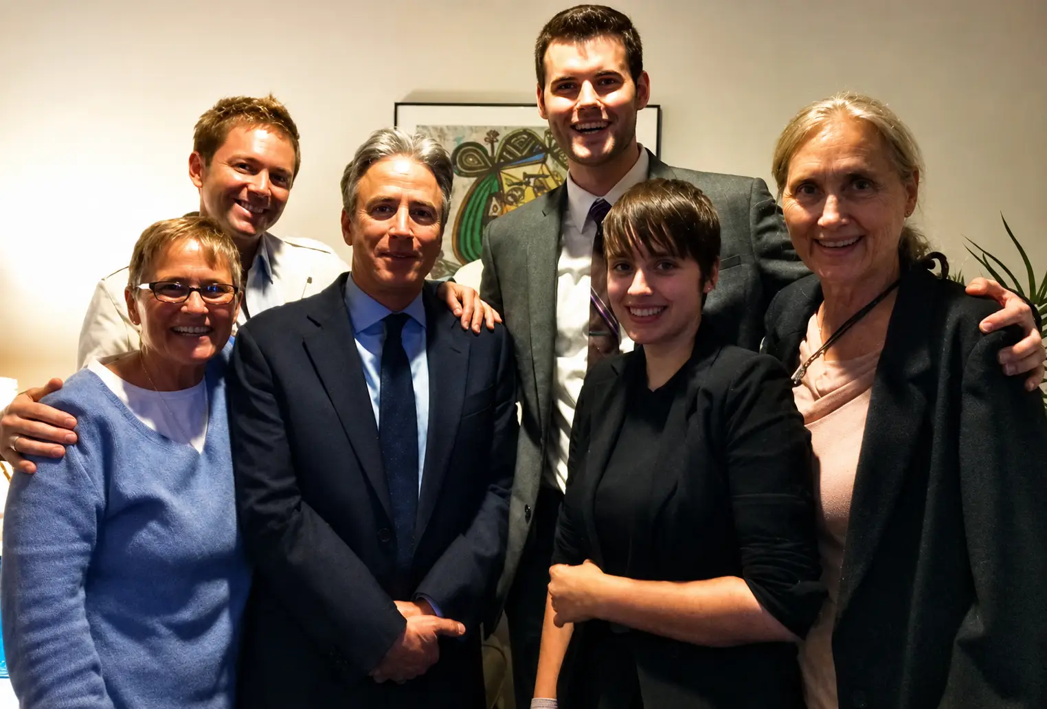 Group of six people smiling together.