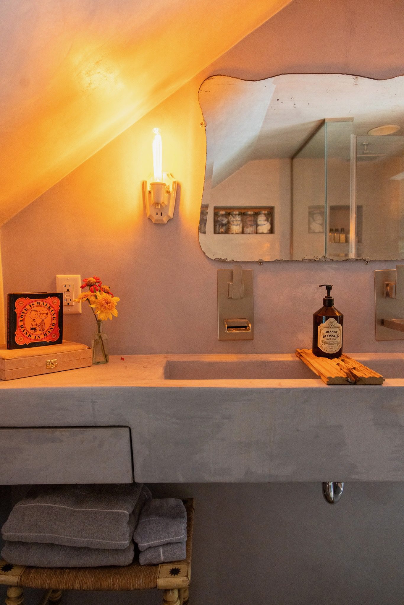 Cozy bathroom with mirror and warm lighting.