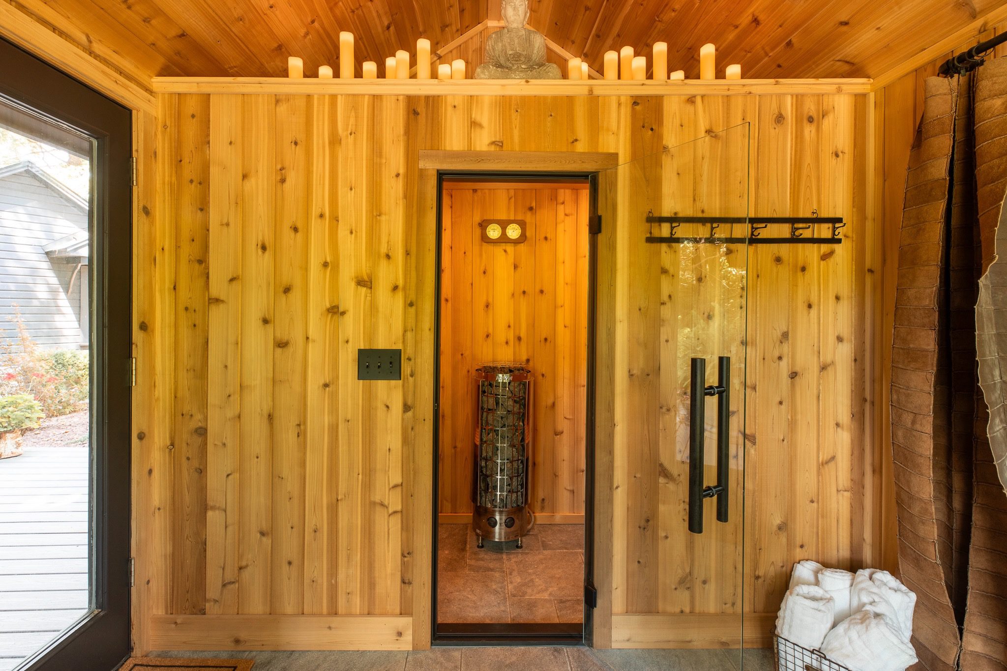 Wooden sauna room with warm lighting.