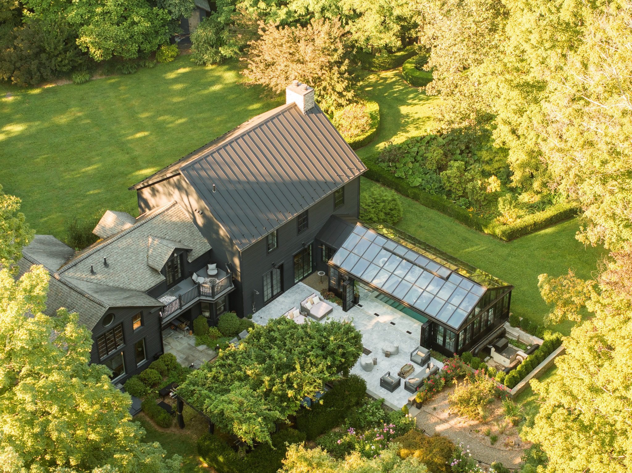 Aerial view of house with lush garden.