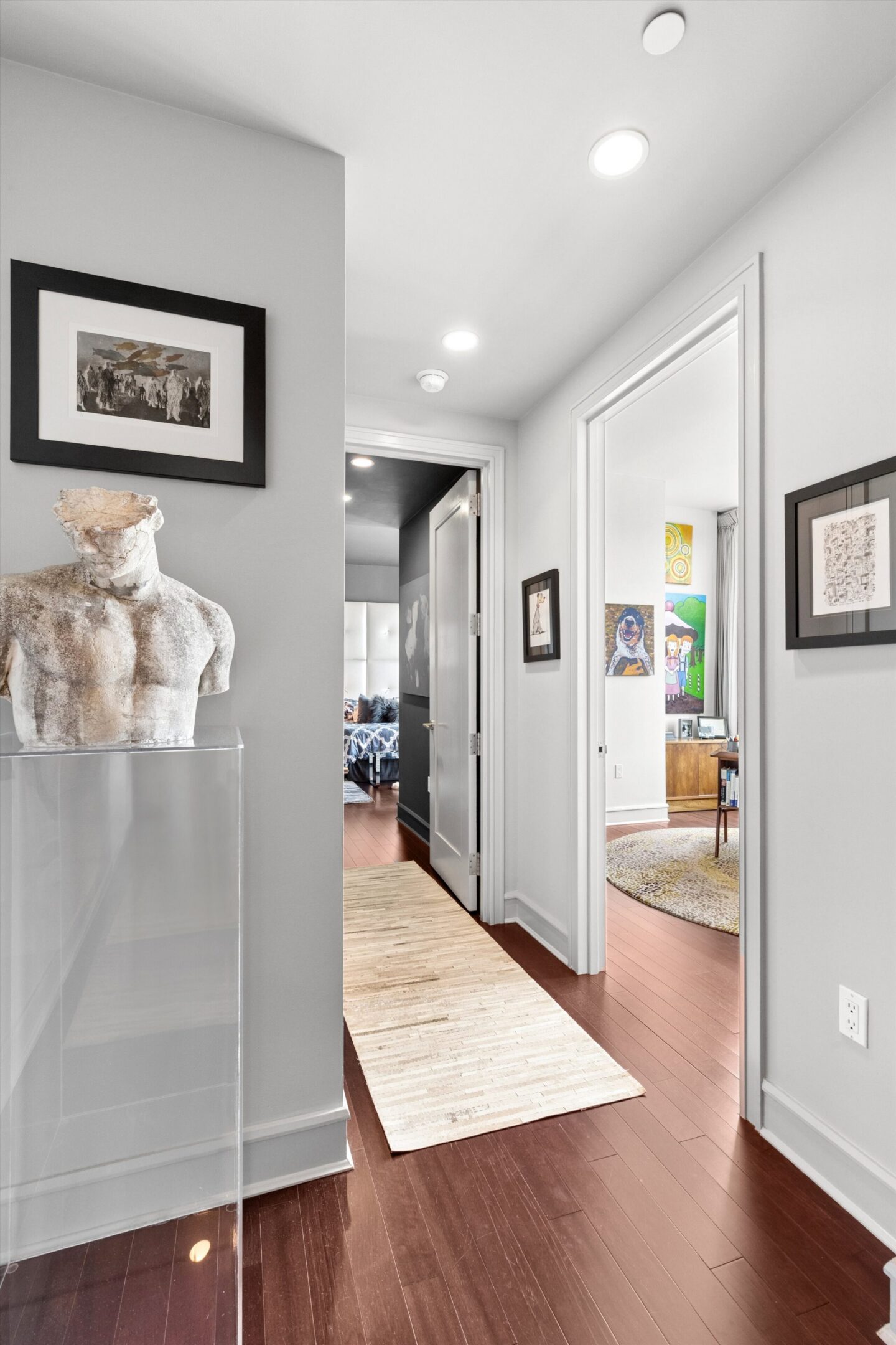 Modern hallway with art and sculpture display.