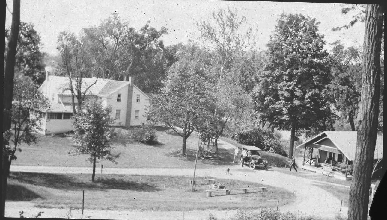 Vintage rural scene with houses and trees.