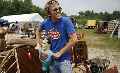 Person with Superman bust at outdoor fair
