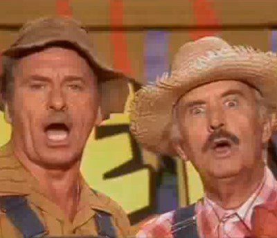 Surprised duo in hats on stage