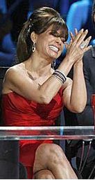 Woman in red dress clapping