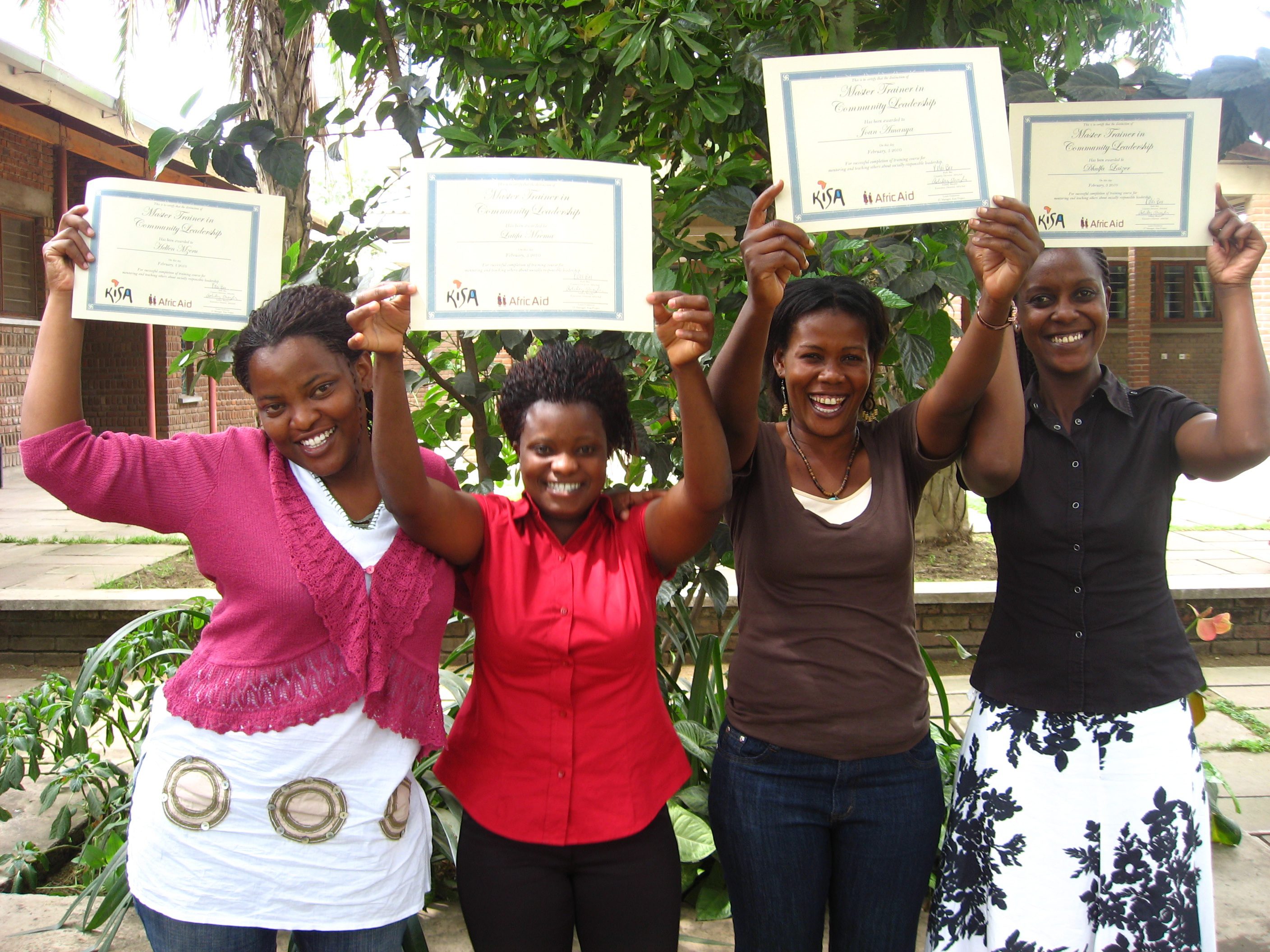 Group of women holding certificates proudly