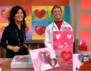 Smiling duo presenting colorful heart crafts
