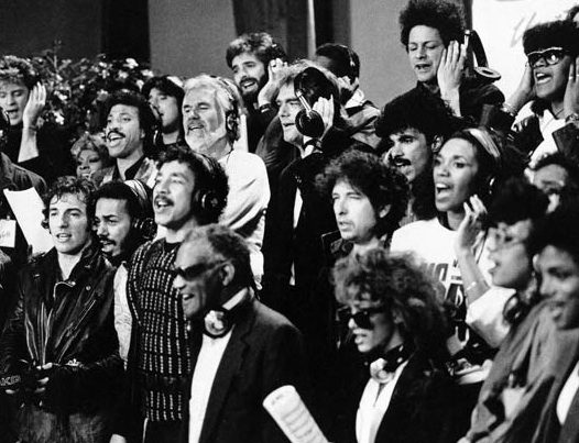 Singers wearing headphones in recording session