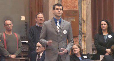 Man in suit giving a speech indoors
