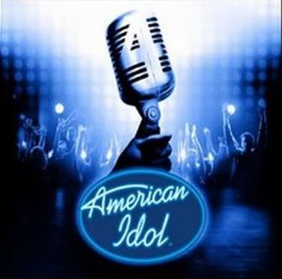 Hand holding microphone with blue background