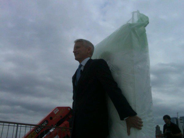 Individual in formal wear with big package