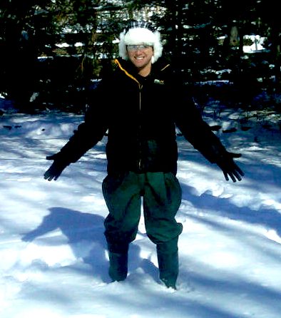Person standing in snowy forest