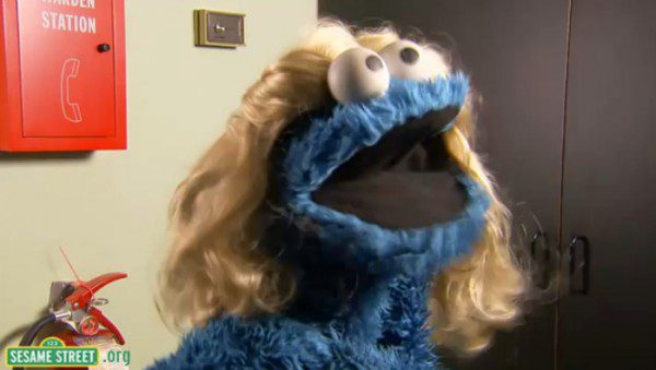 Blue puppet with blonde wig