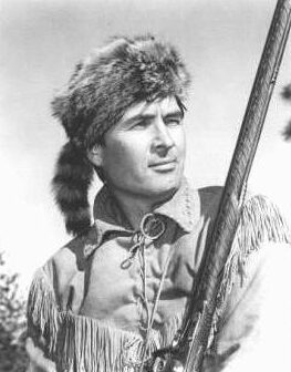 Historical figure holding a rifle outdoors