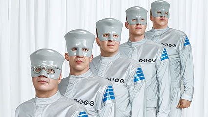 Band members in silver futuristic attire