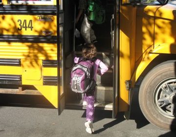 Student getting on school bus