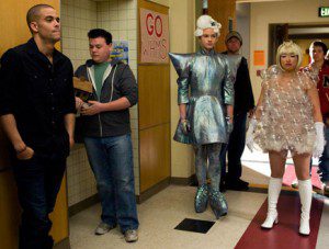 Group dressed in futuristic outfits indoors