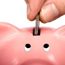 Saving money in piggy bank slot