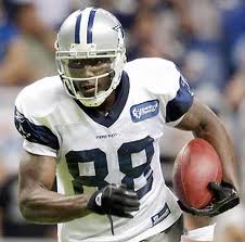 Player in white jersey holding football