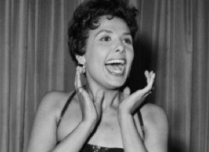 Woman smiling with hands on cheeks