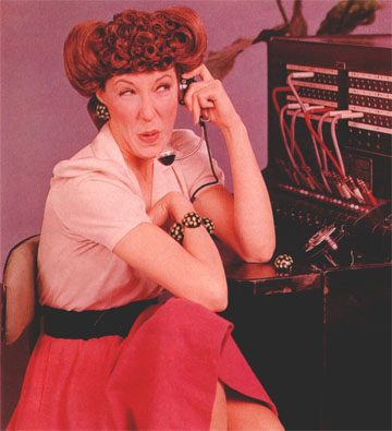 Woman at vintage telephone switchboard