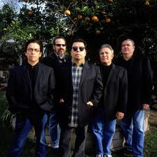 Five men standing outdoors in black jackets