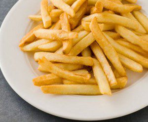 Golden fries on white plate