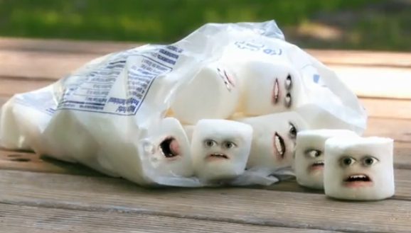 Marshmallows with funny faces on table