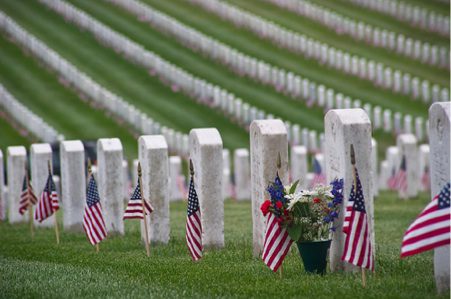 Flags and flowers on cemetery graves