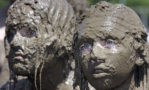 Mud-covered faces at festival
