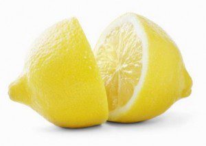 Whole and sliced lemon on white background.