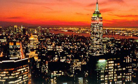 City skyline at sunset with glowing lights